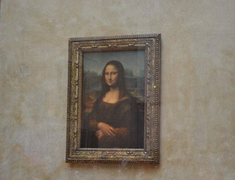 Leonardo da Vinci's Mona Lisa painting displayed alone in the Louvre Museum, protected by climate-controlled bulletproof glass.